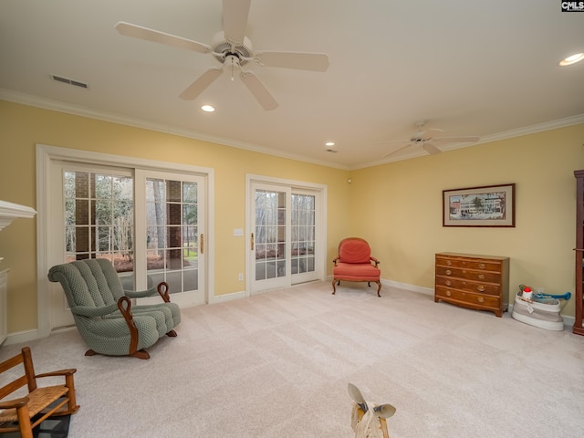 sitting room featuring carpet and ornamental molding