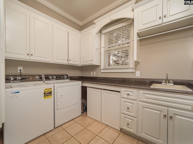 laundry area with crown molding, cabinet space, light tile patterned flooring, a sink, and independent washer and dryer