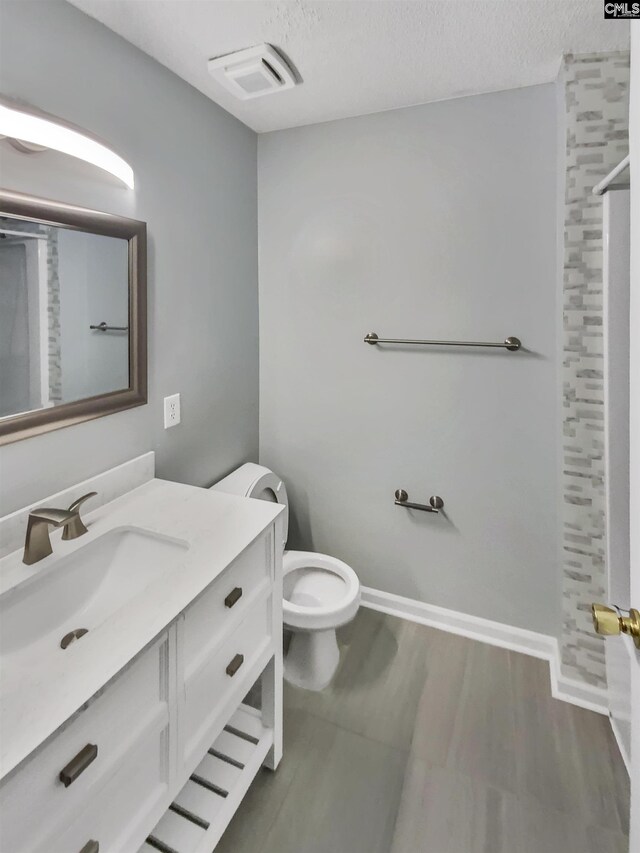 full bath featuring vanity, a shower, and visible vents