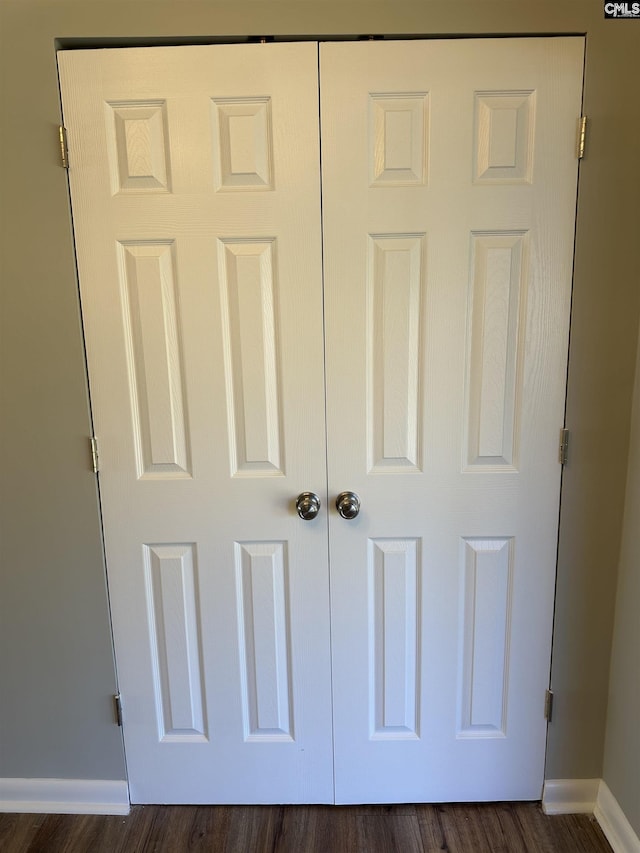 interior details featuring baseboards and wood finished floors