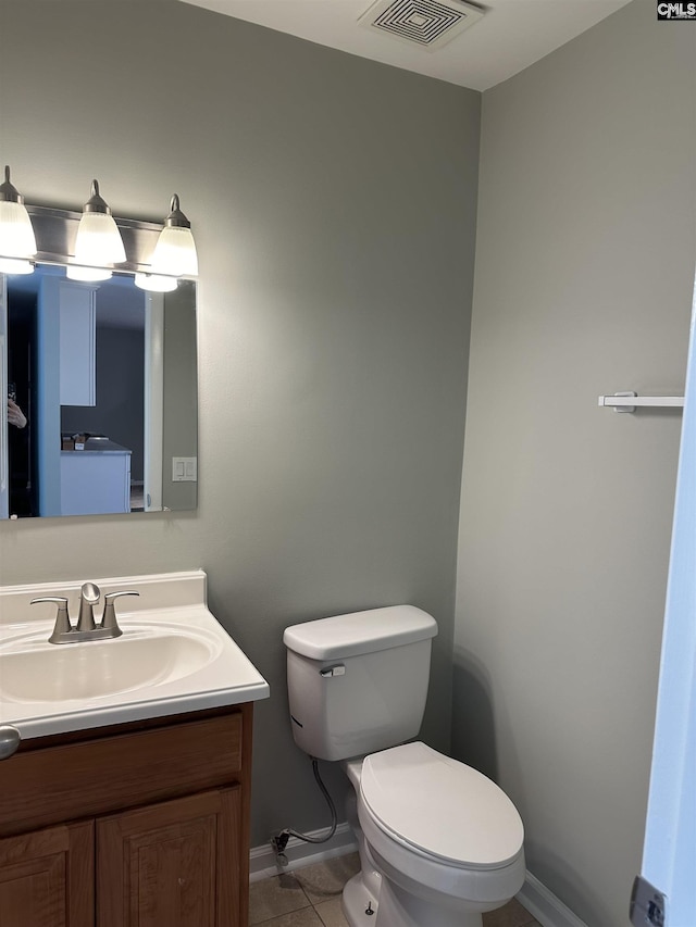 half bath featuring visible vents, baseboards, toilet, tile patterned floors, and vanity