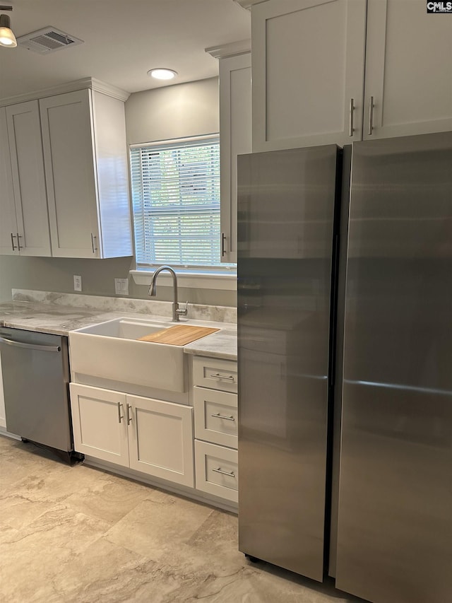 kitchen with white cabinetry, visible vents, appliances with stainless steel finishes, and a sink