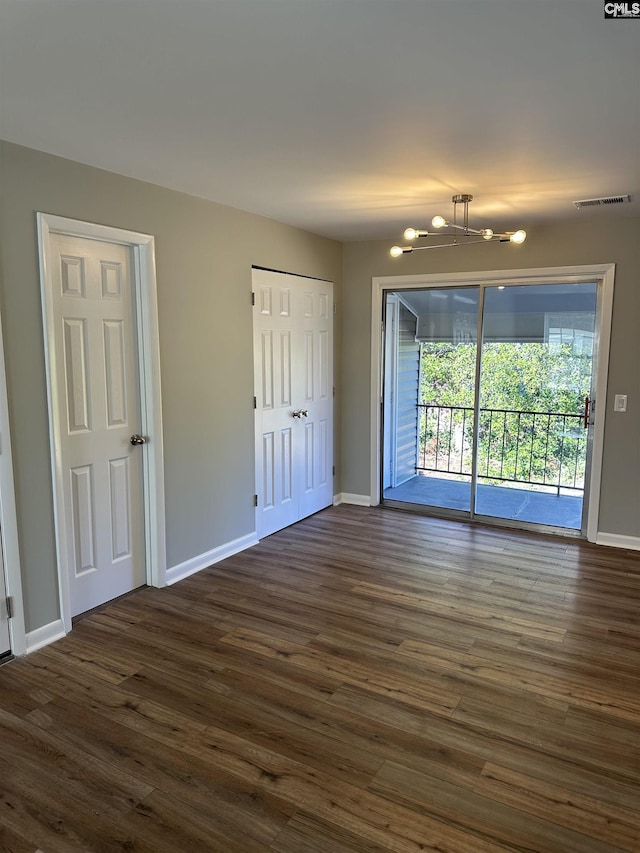 interior space featuring visible vents, dark wood finished floors, and access to outside