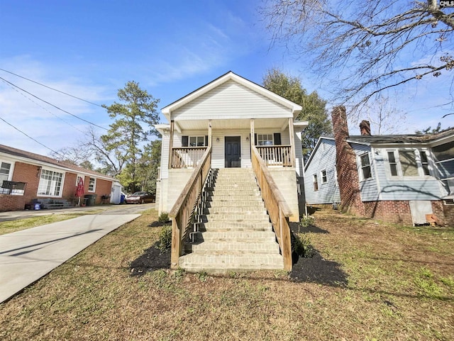 view of front of property with stairway and a porch