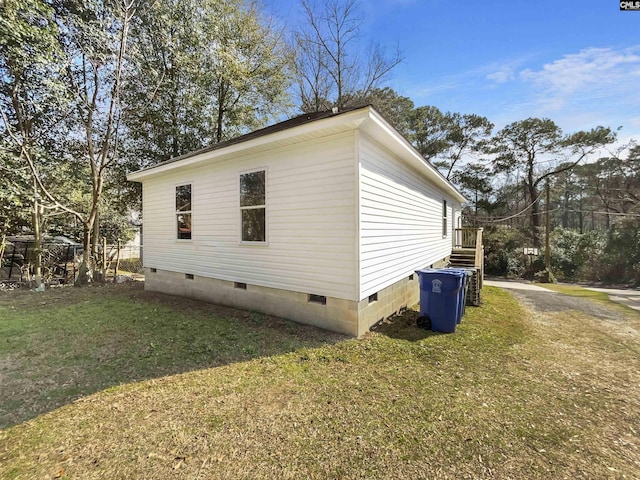 view of property exterior with a lawn and crawl space