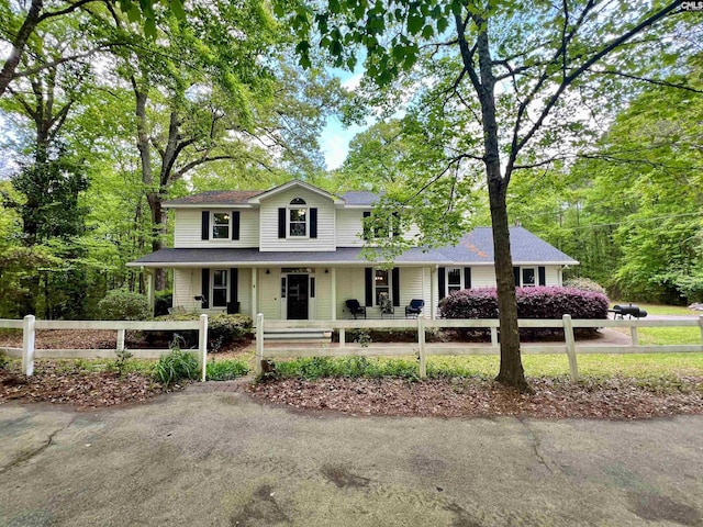 view of front of home with a porch and a fenced front yard