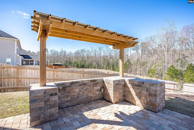 view of patio / terrace featuring a pergola and fence