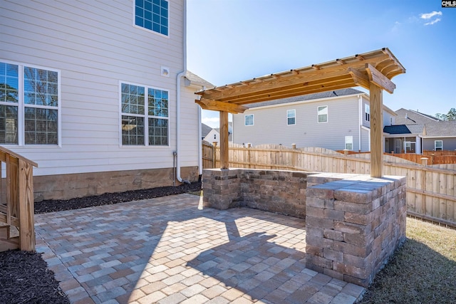 view of patio featuring fence and a pergola