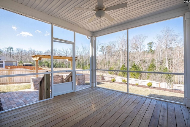 unfurnished sunroom with plenty of natural light and ceiling fan