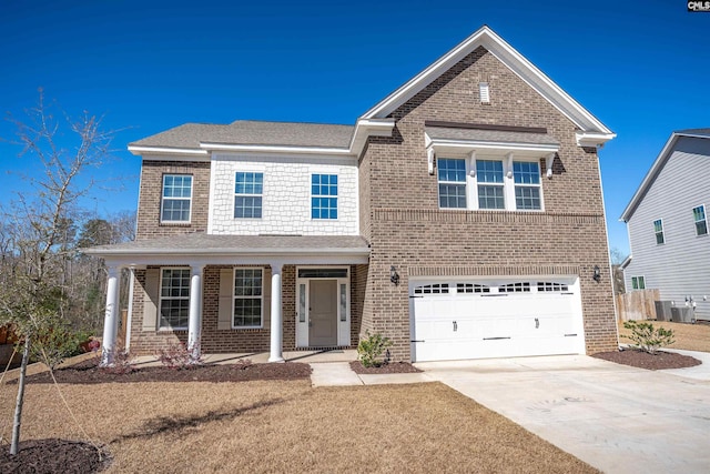 traditional-style house featuring a garage, brick siding, and driveway