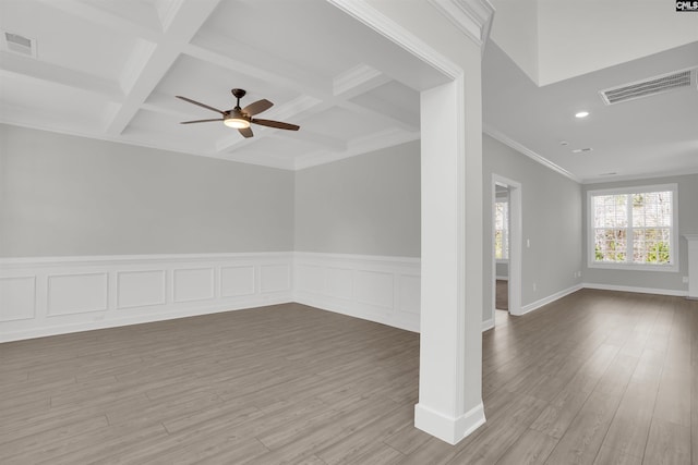 unfurnished room featuring beam ceiling, visible vents, and wood finished floors