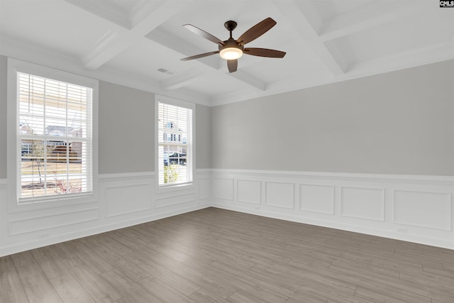 unfurnished room featuring a ceiling fan, beamed ceiling, light wood-style floors, and coffered ceiling