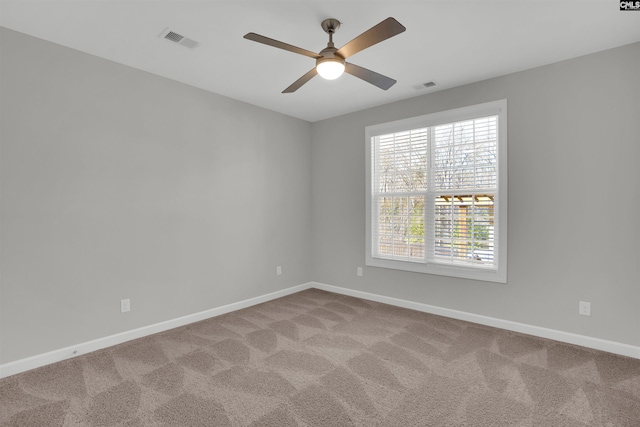 unfurnished room with visible vents, baseboards, and carpet