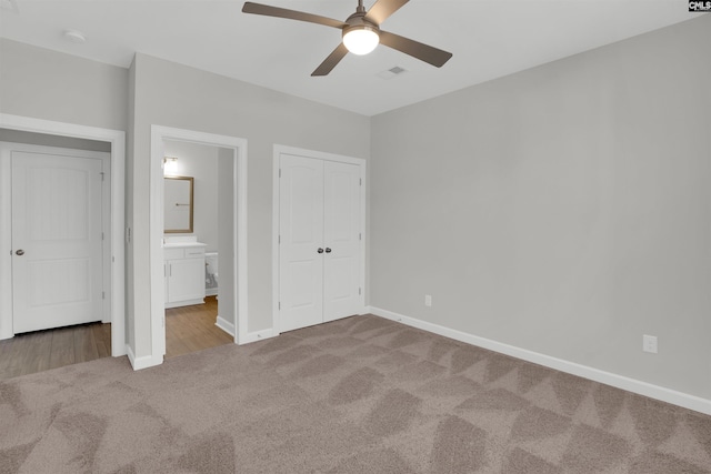 unfurnished bedroom featuring visible vents, baseboards, carpet floors, a closet, and ensuite bath