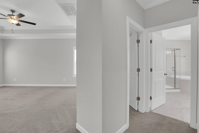 hallway with crown molding, carpet, visible vents, and baseboards