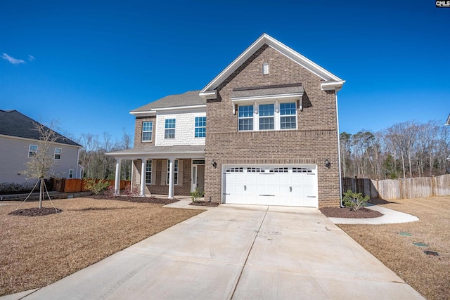 traditional home with brick siding, an attached garage, fence, a porch, and driveway