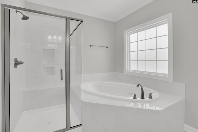 bathroom featuring a bath, a shower stall, and ornamental molding