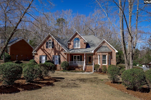 view of front of home featuring brick siding, crawl space, and covered porch