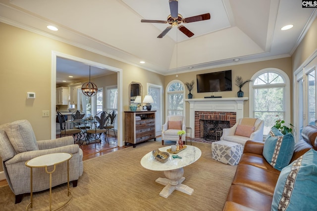 living area with recessed lighting, plenty of natural light, ornamental molding, and a fireplace