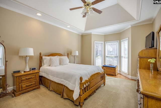 bedroom featuring light carpet, a raised ceiling, crown molding, baseboards, and ceiling fan