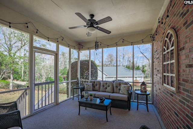 unfurnished sunroom with ceiling fan