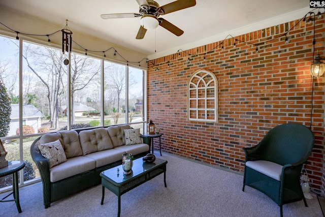 living area featuring brick wall, ceiling fan, and carpet floors