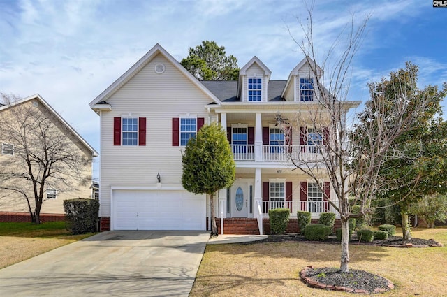 view of front of house with a front lawn, concrete driveway, covered porch, a garage, and a balcony