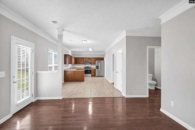 257 Castlebury Dr, Columbia, SC 29229 - kitchen with brown cabinetry, visible vents, light countertops, light wood-style floors, and appliances with stainless steel finishes