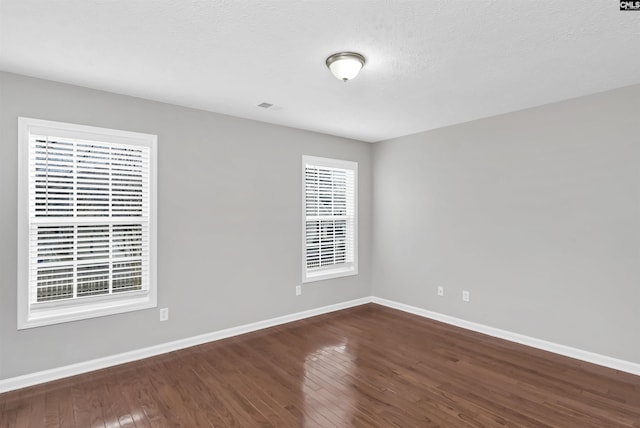 257 Castlebury Dr, Columbia, SC 29229 - unfurnished room featuring dark wood finished floors, visible vents, baseboards, and a textured ceiling