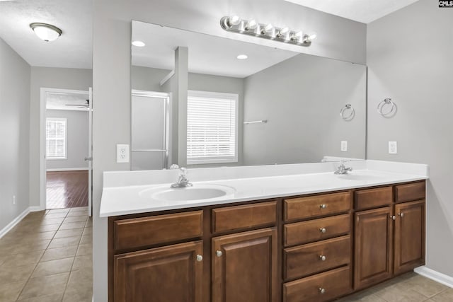 257 Castlebury Dr, Columbia, SC 29229 - bathroom with tile patterned flooring, double vanity, ceiling fan, and a sink