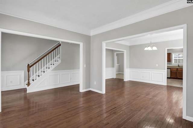 257 Castlebury Dr, Columbia, SC 29229 - empty room featuring stairway, dark wood finished floors, ornamental molding, a decorative wall, and a notable chandelier