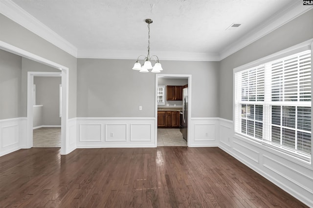 257 Castlebury Dr, Columbia, SC 29229 - unfurnished dining area featuring visible vents, a wainscoted wall, a chandelier, and dark wood finished floors