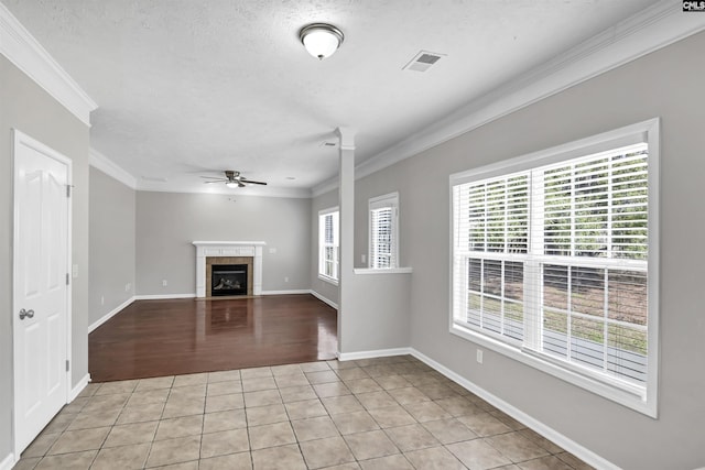 257 Castlebury Dr, Columbia, SC 29229 - unfurnished living room featuring light tile patterned floors, baseboards, a fireplace, ornamental molding, and ceiling fan