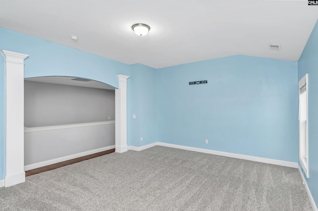 spare room with visible vents, carpet flooring, baseboards, and decorative columns