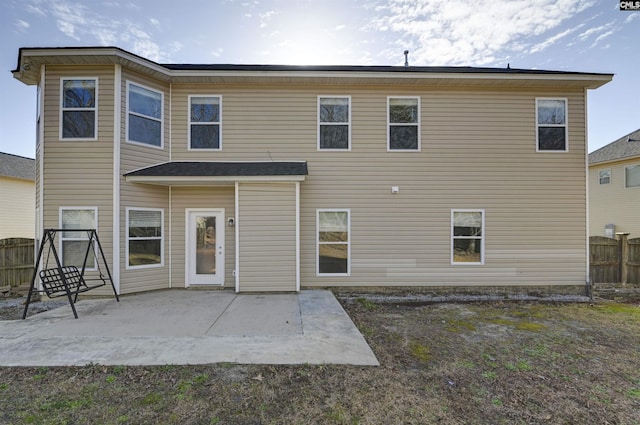 back of property featuring a patio area and fence