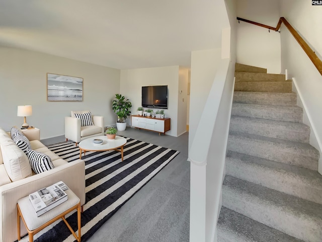 living room with stairs and concrete floors