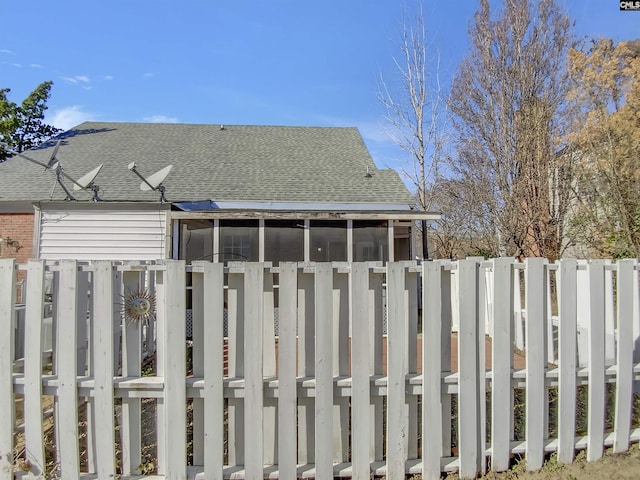 exterior space with fence and a sunroom