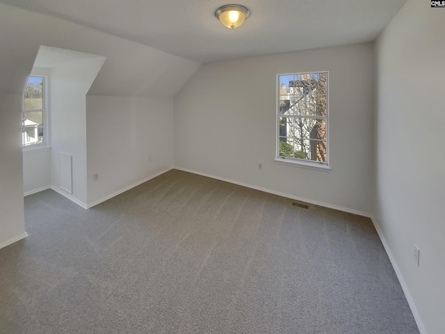 bonus room featuring visible vents, baseboards, carpet floors, and vaulted ceiling