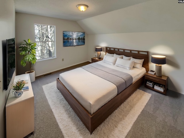 bedroom featuring baseboards, visible vents, lofted ceiling, and carpet floors