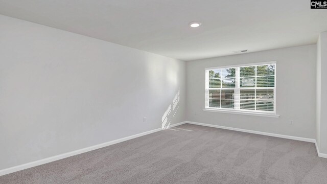 empty room featuring visible vents, baseboards, and carpet floors