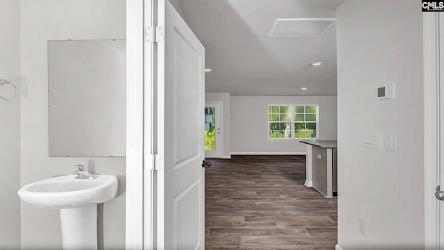 bathroom with wood finished floors, visible vents, and baseboards