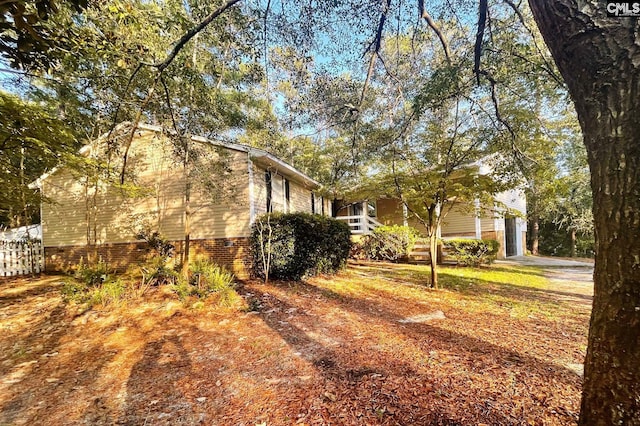 view of property exterior featuring fence and a garage