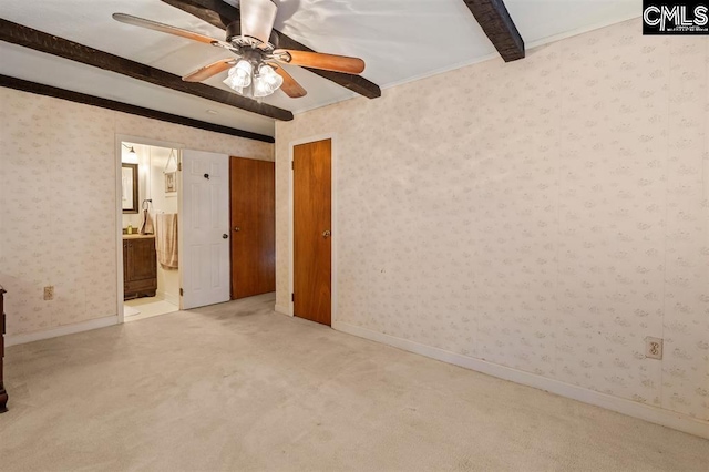 interior space featuring wallpapered walls, beamed ceiling, carpet flooring, and baseboards