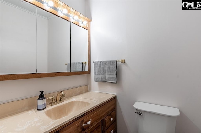 half bathroom with toilet and vanity