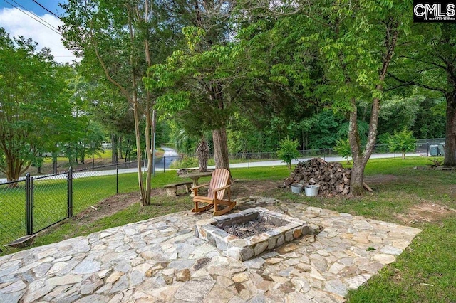 view of patio featuring fence and an outdoor fire pit