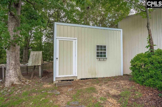 view of shed featuring fence