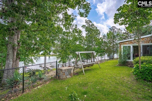 view of yard featuring a fenced backyard and a water view