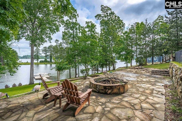 view of patio with a fire pit, a dock, and a water view