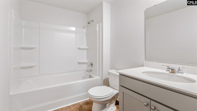 1304 Mosser Dr, Columbia, SC 29203 - bathroom featuring vanity, washtub / shower combination, toilet, and wood finished floors