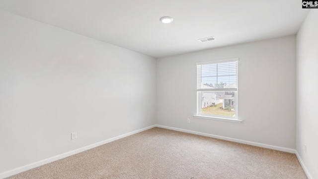 1304 Mosser Dr, Columbia, SC 29203 - spare room with light colored carpet, visible vents, and baseboards